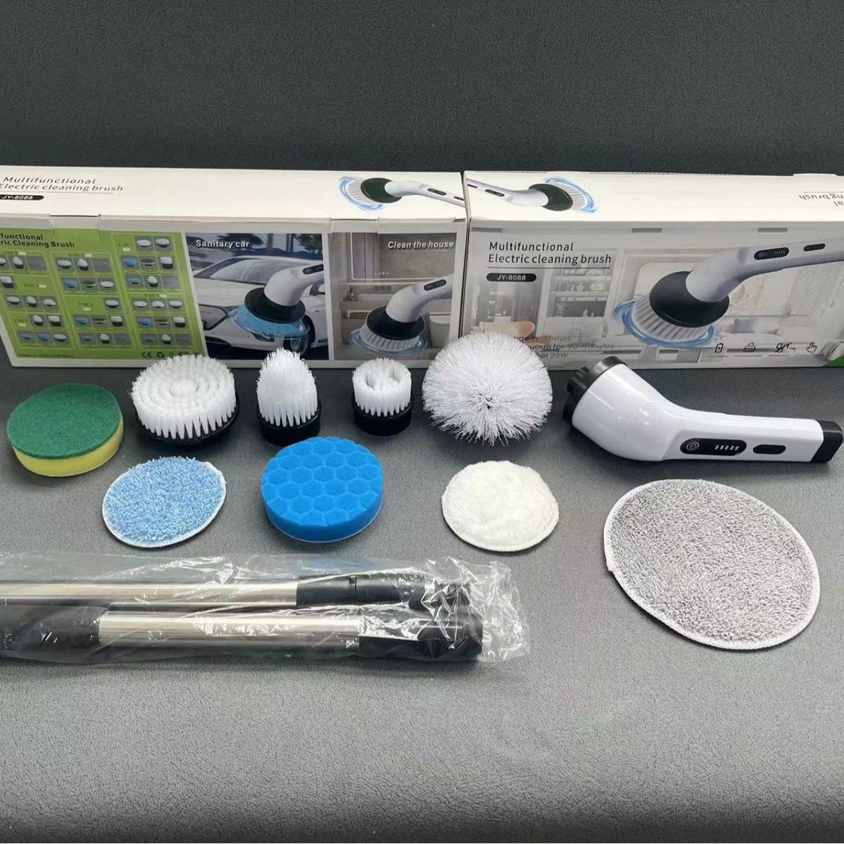 Fotografía real del cepillo de limpieza eléctrico desplegado con sus 9 cabezales intercambiables, tubo extensible y cajas originales de empaque