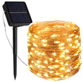 Guirnalda de luces navideñas solares LED cálidas de 10 metros con panel solar y estaca para jardín.
